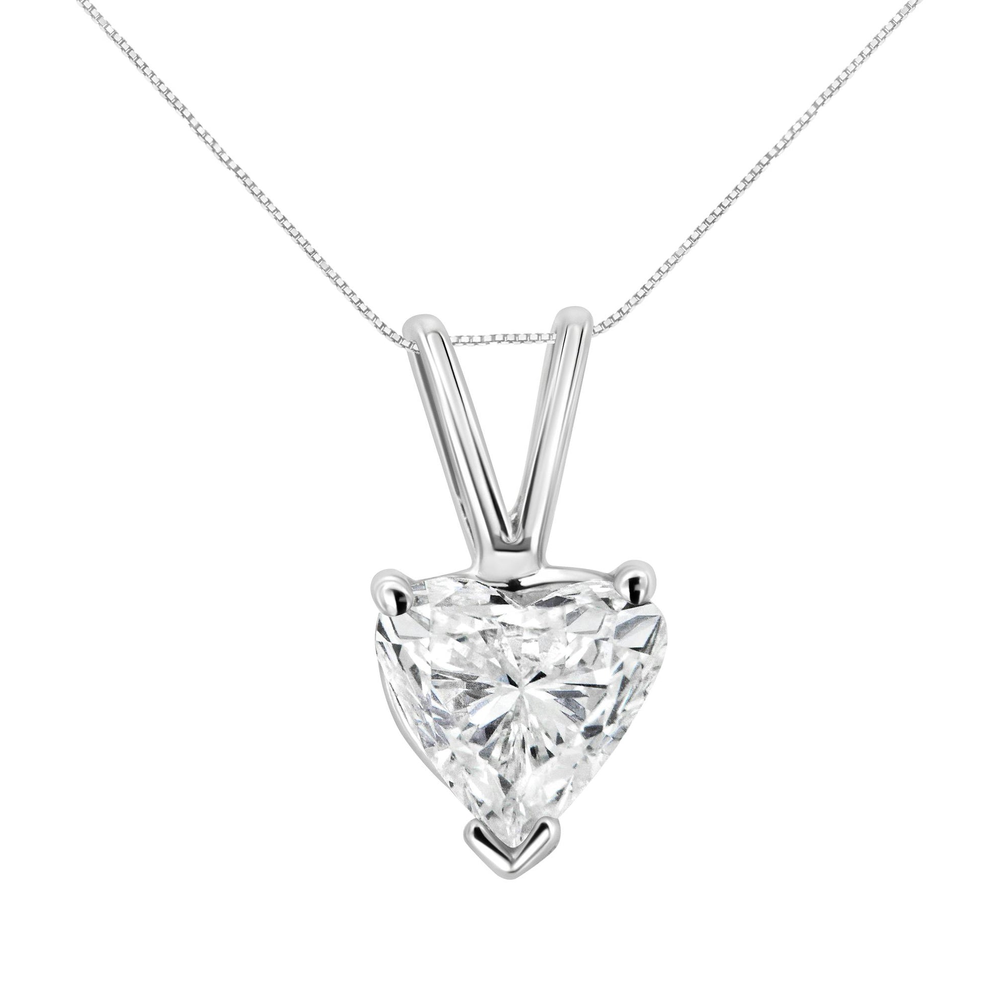 Front-facing close-up of a white metal necklace with a heart-shaped white gemstone pendant in a three-prong setting.