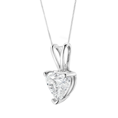 Close-up angled view of a white metal necklace featuring a heart-shaped white gemstone in a three-prong setting.