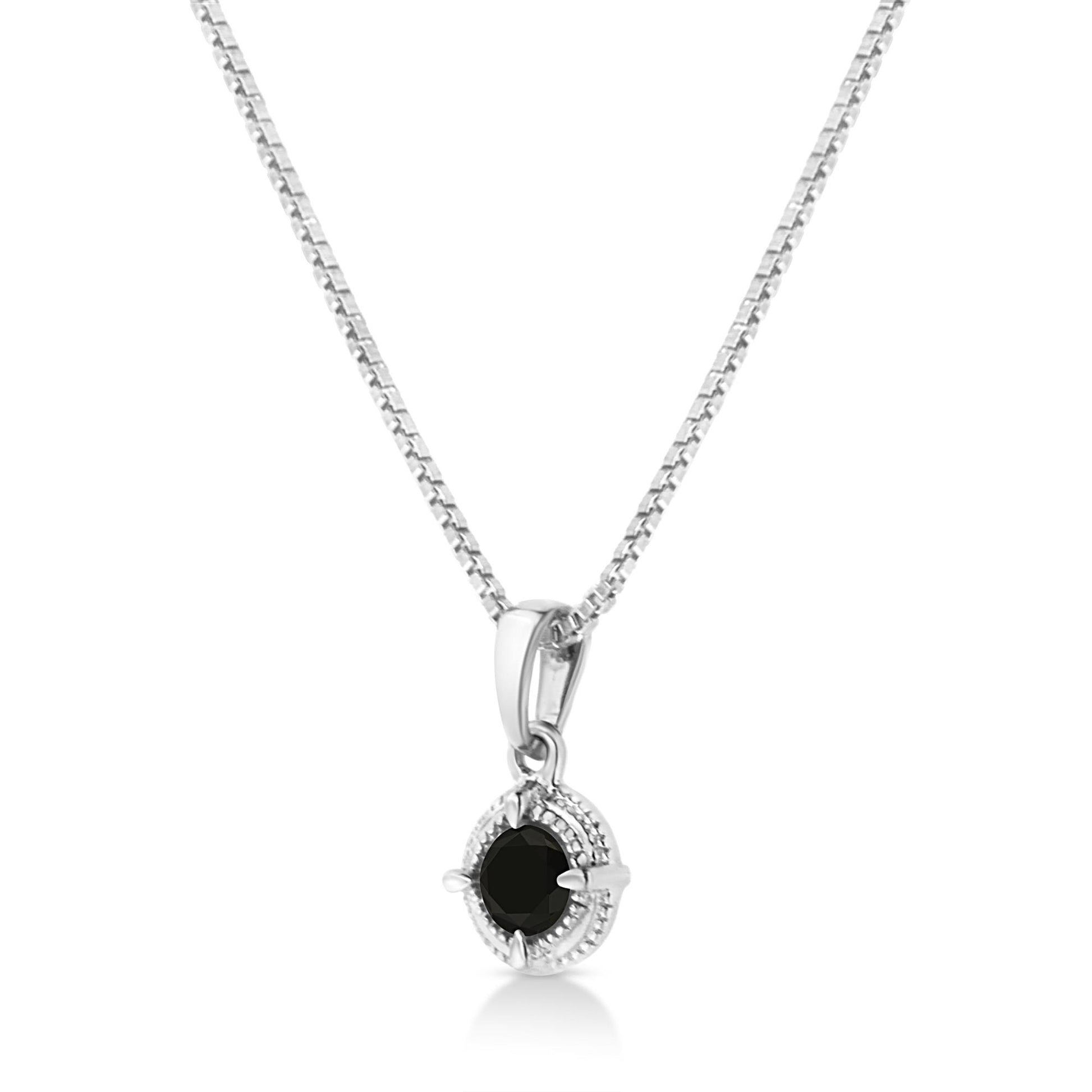 Front-facing image of a white metal necklace with a round black gemstone pendant in a four-prong setting.