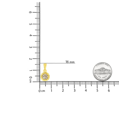 Close-up front view of a yellow metal necklace pendant with a round brownish gemstone in a four-prong setting, shown on a ruler and scale for size reference.