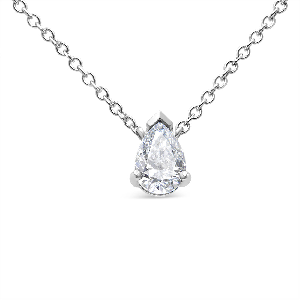 Front angle view of a white metal necklace with a single pear-shaped white gemstone in a prong setting.
