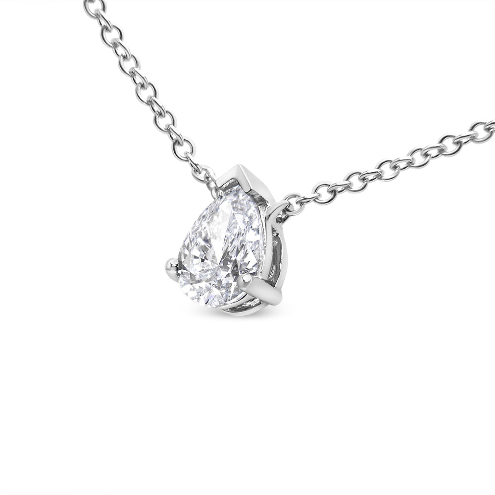 Close-up front angle of a white metal necklace with a pear-shaped white gemstone in a prong setting.