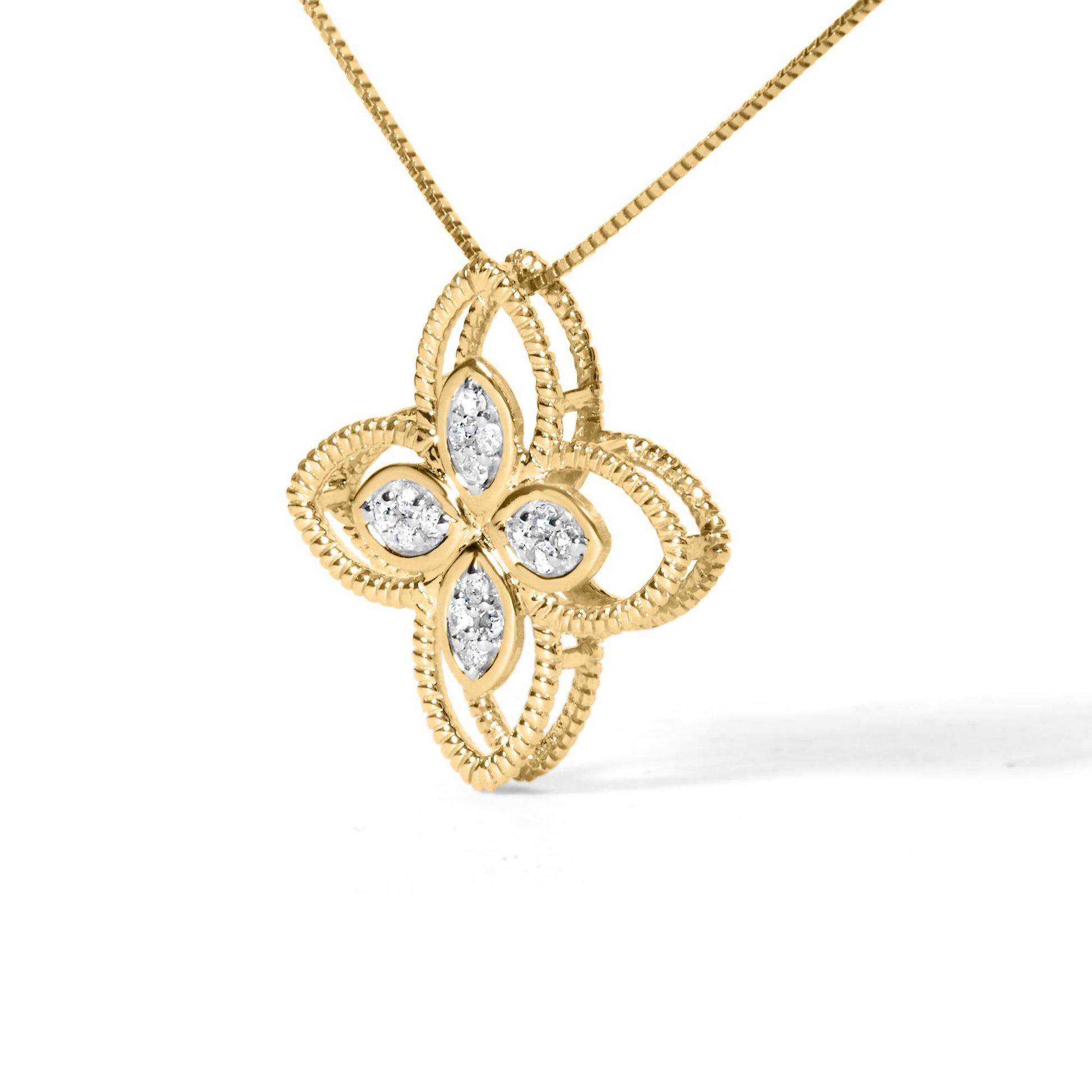 Yellow metal necklace with a quatrefoil-shaped pendant featuring round white gemstones in prong settings, shown in a close-up front angle.