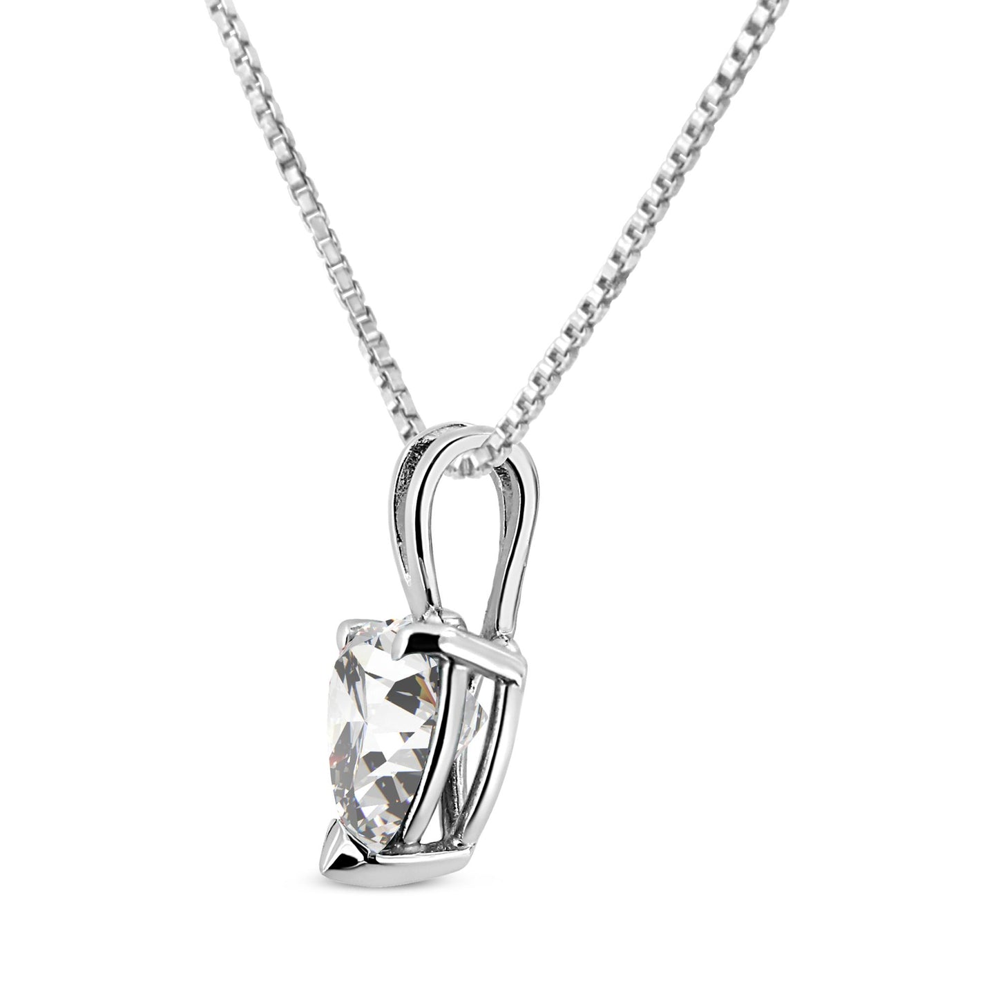 Close-up angled view of a white metal necklace with a heart-shaped white gemstone in a three-prong setting.