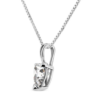 Close-up angled view of a white metal necklace with a heart-shaped white gemstone in a three-prong setting.
