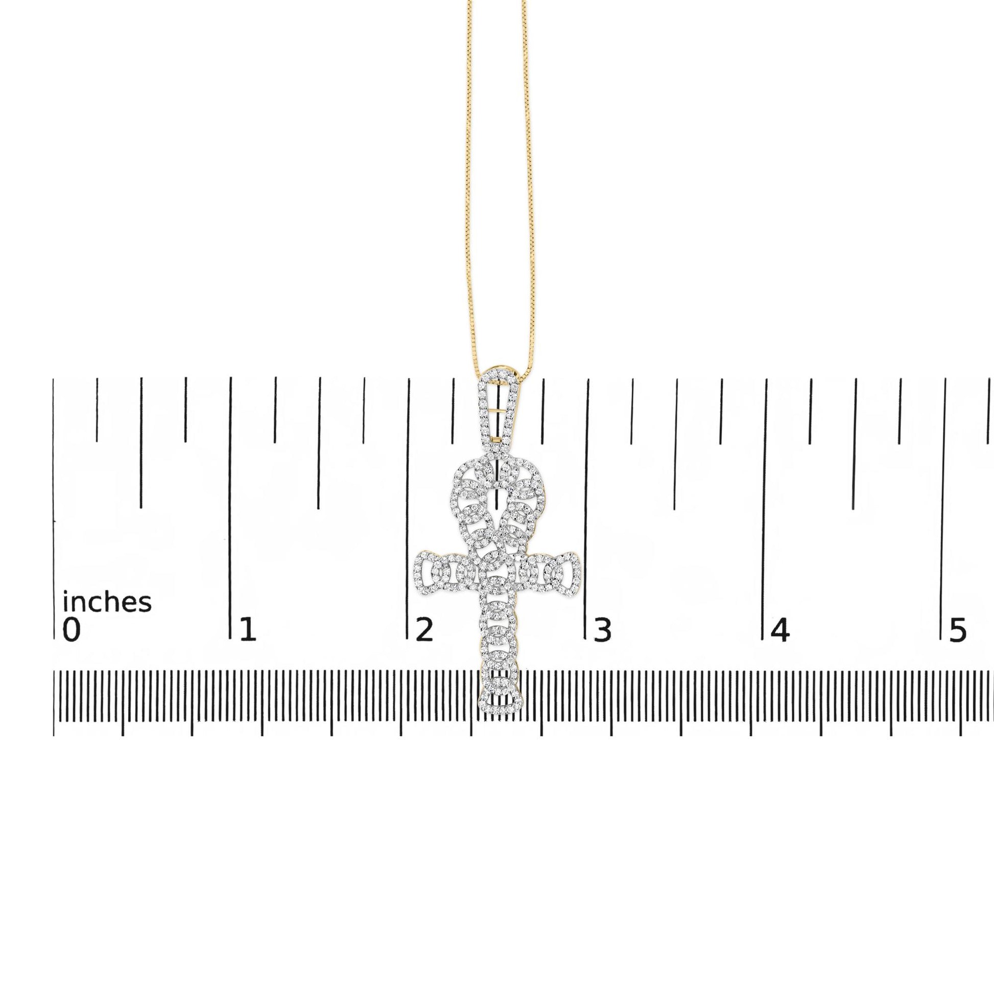 Yellow necklace with a cross-shaped pendant adorned with white round gemstones in prong settings, shown hanging vertically on a measurement scale, front view.