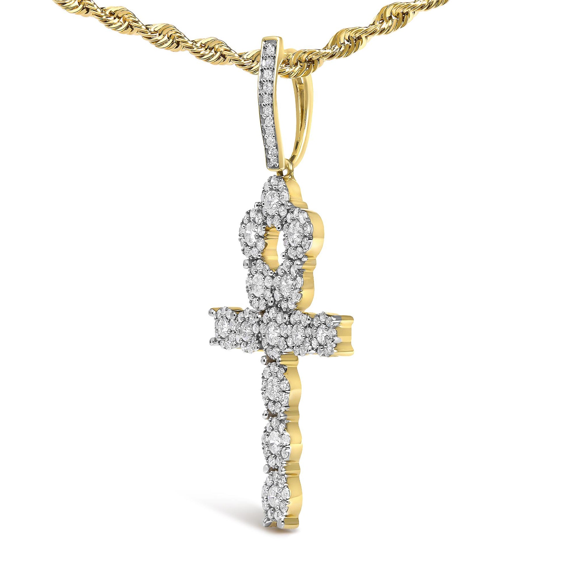 Close-up front angle of a yellow metal necklace with a cross-shaped pendant encrusted with round white gemstones in prong settings.