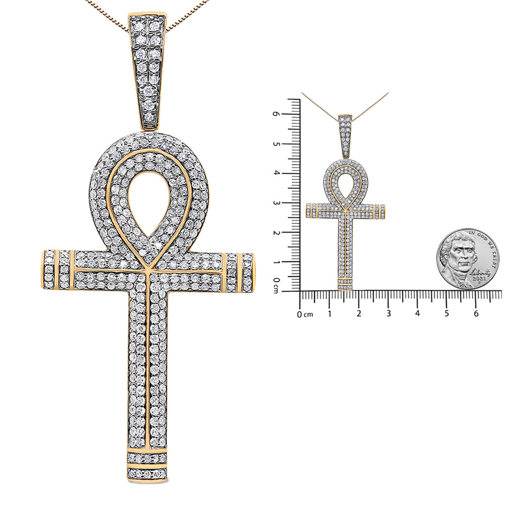 Yellow metal ankh-shaped necklace pendant with round white gemstones in prong settings, shown in a front close-up and on a ruler and coin for size reference.