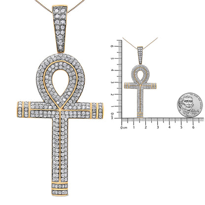 Yellow metal ankh-shaped necklace pendant with round white gemstones in prong settings, shown in a front close-up and on a ruler and coin for size reference.