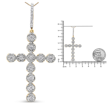 Front view of a yellow metal cross-shaped necklace pendant with round white gemstones in prong settings, shown alongside a size reference ruler and a coin.