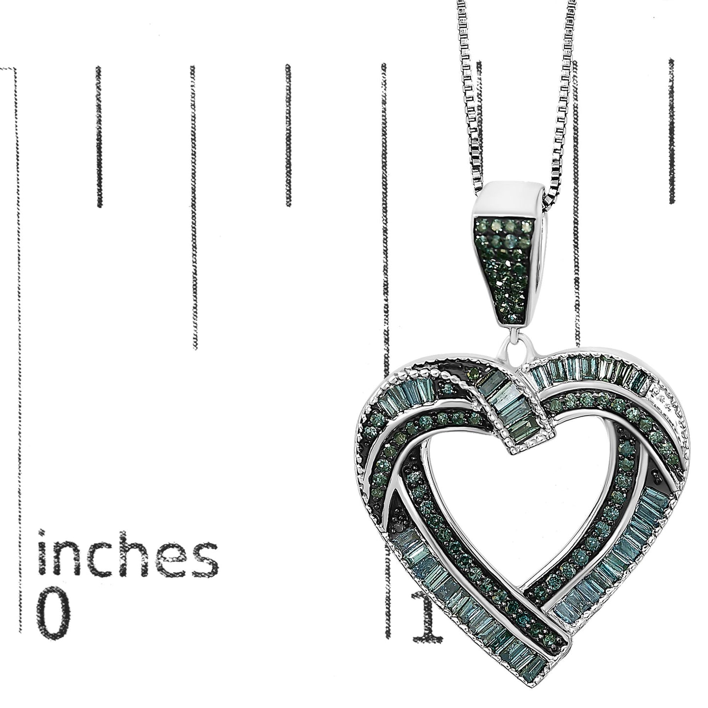 White metal necklace pendant in an intertwined heart shape adorned with blue round gemstones in prong settings and blue baguette gemstones in channel settings, shown on a scale at a close-up angle.
