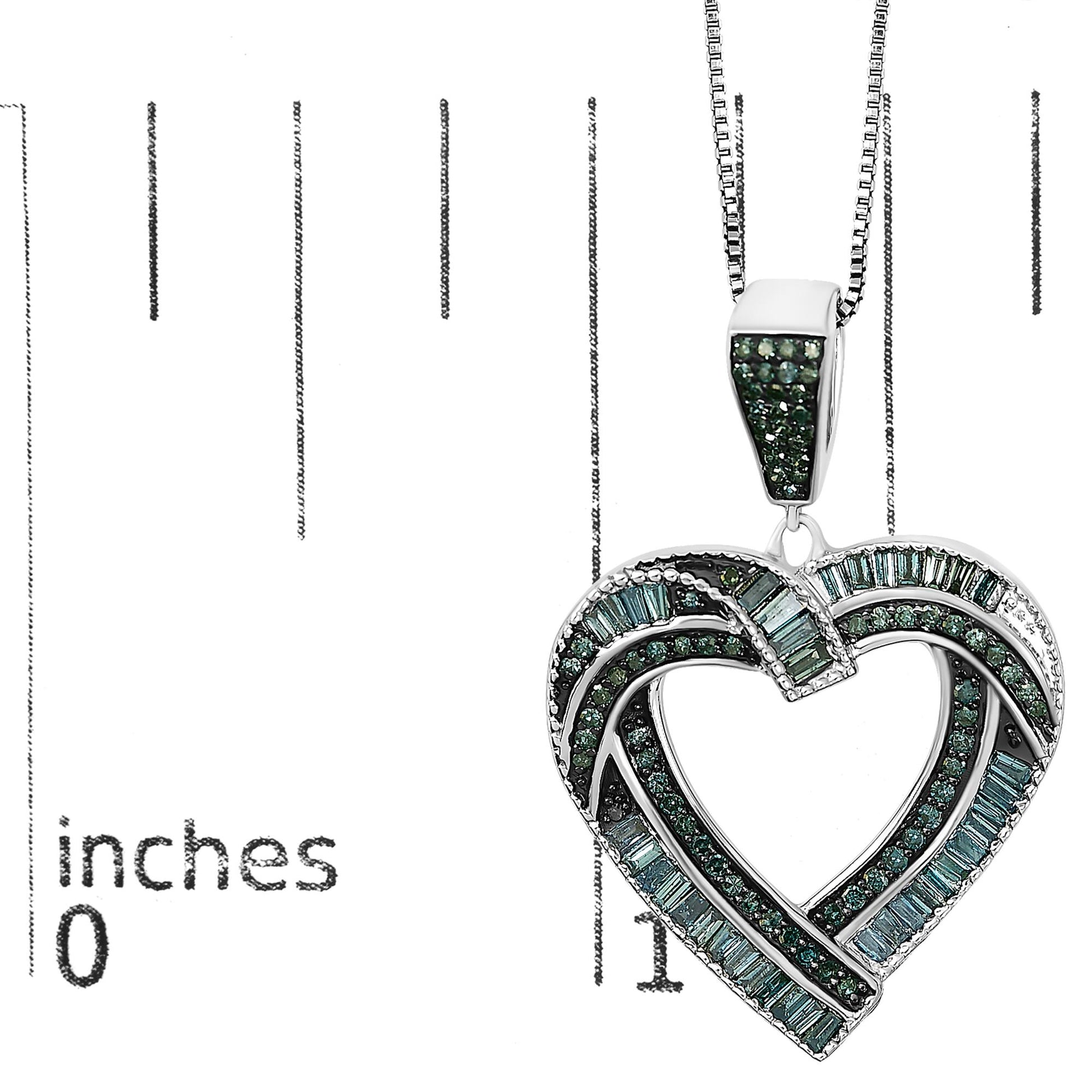 White metal necklace pendant in an intertwined heart shape adorned with blue round gemstones in prong settings and blue baguette gemstones in channel settings, shown on a scale at a close-up angle.