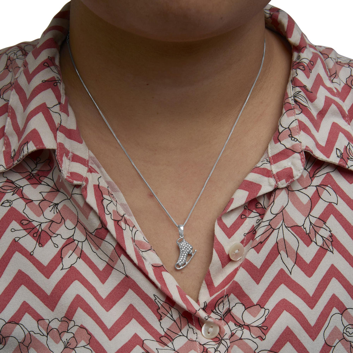 Sterling silver diamond ice skate pendant necklace worn by a model