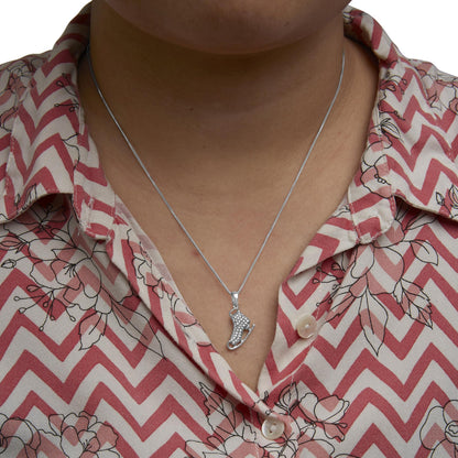 Sterling silver diamond ice skate pendant necklace worn by a model