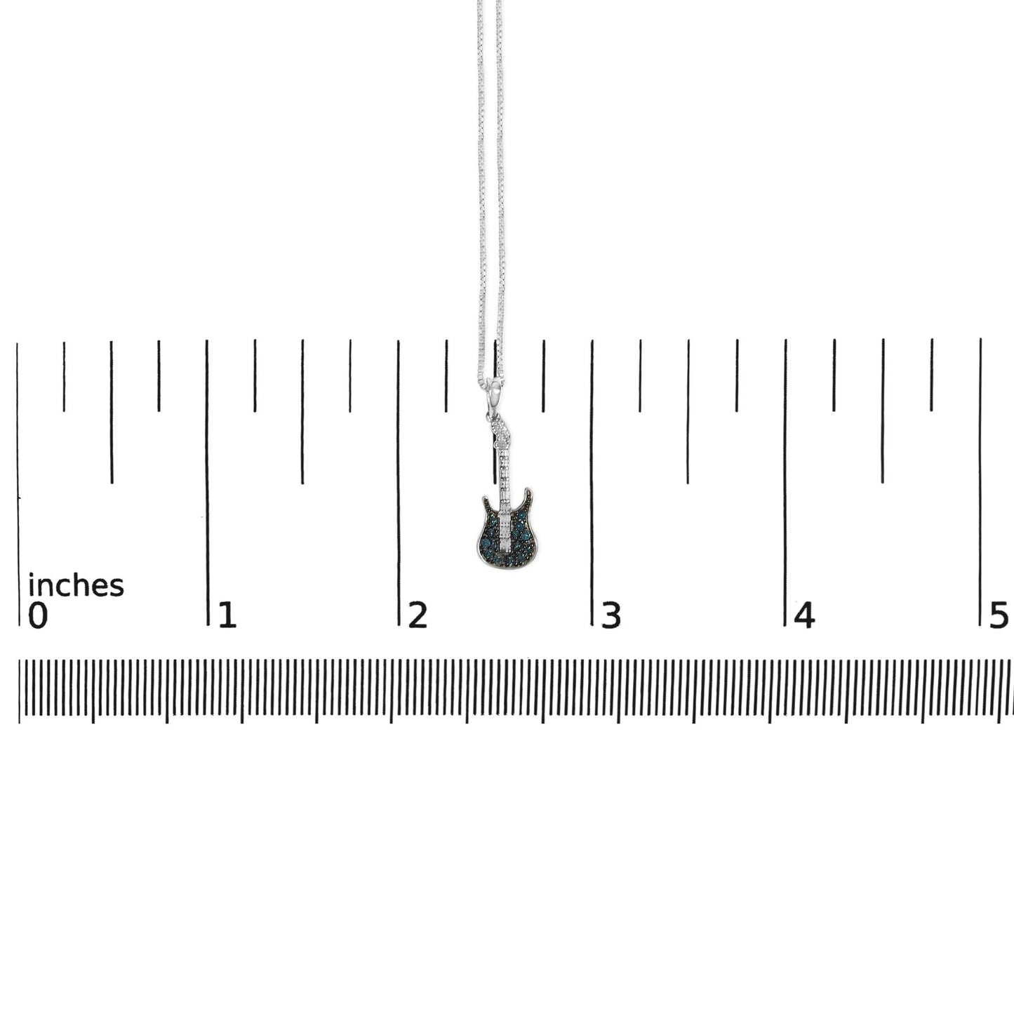 White metal necklace with a guitar-shaped pendant featuring blue round gemstones in prong settings, shown from the front on a ruler for size reference.