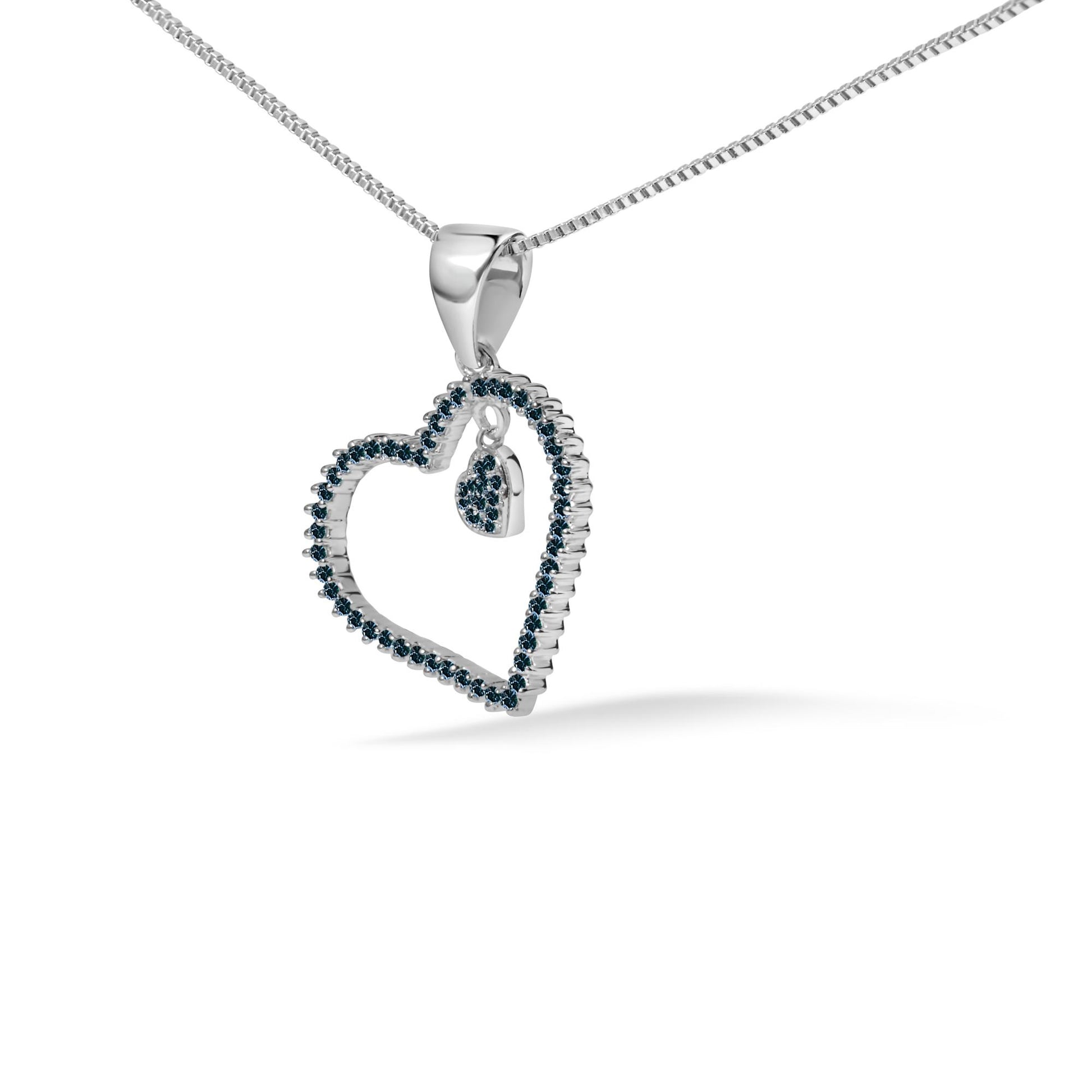 Close-up front angle of a white metal necklace with a heart-shaped pendant outlined with round blue gemstones in prong settings, shown on a white background.