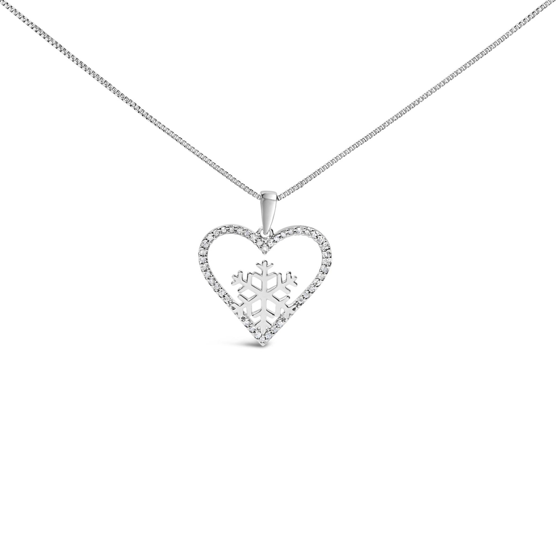 Close-up front view of a white metal necklace with a heart-shaped pendant encrusted with small white gemstones and a snowflake design inside the heart, shown on a white background.