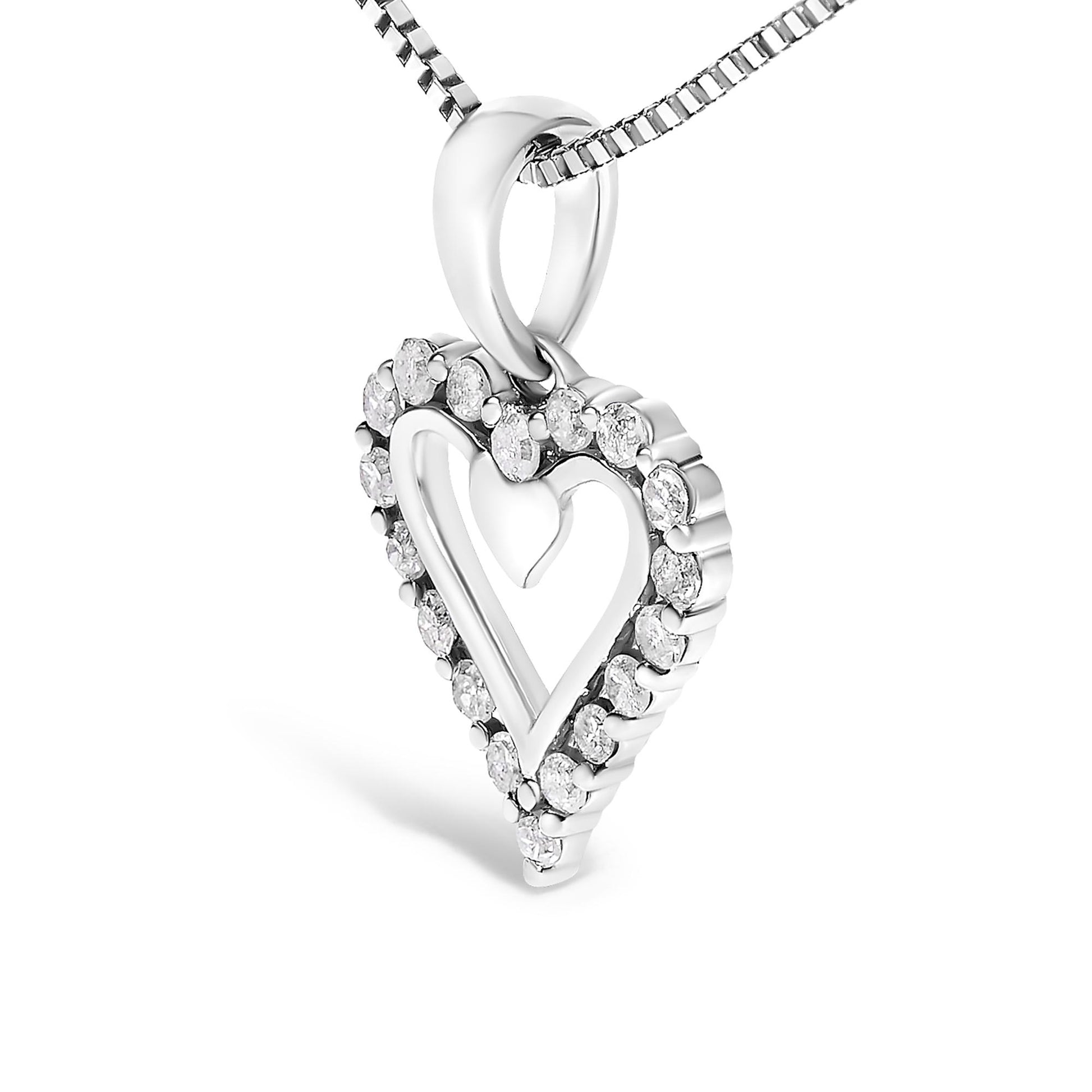 White metal heart-shaped necklace pendant with smaller heart inside, surrounded by round white gemstones in prong setting, shown in close-up front angle.