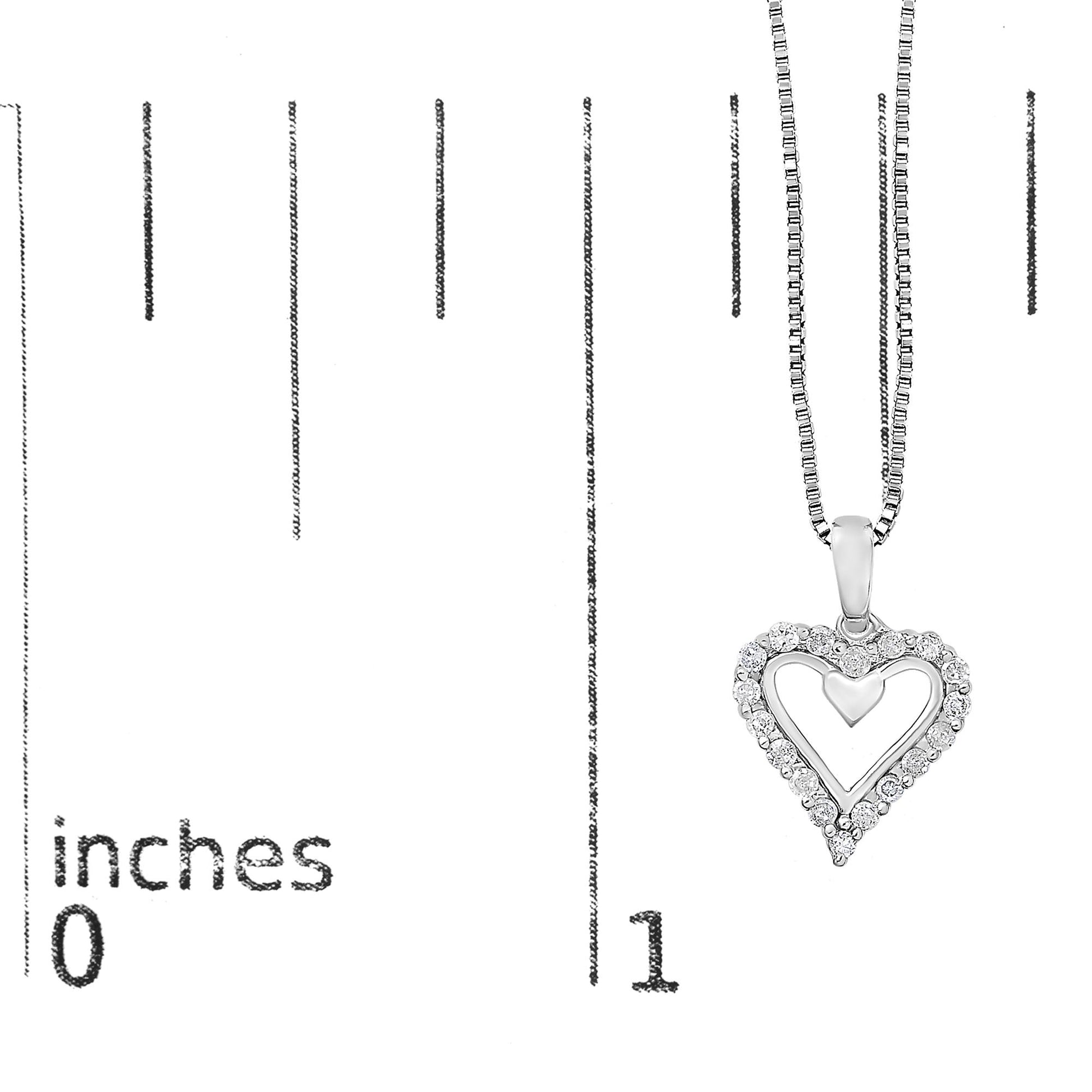 White metal heart-shaped pendant necklace with round white gemstones in prong settings, shown hanging vertically on a ruler for size reference.