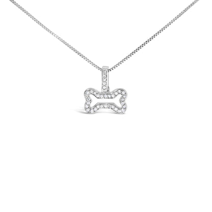 Front-facing shot of a white metal necklace with a bone-shaped pendant outlined with round white gemstones in a prong setting.