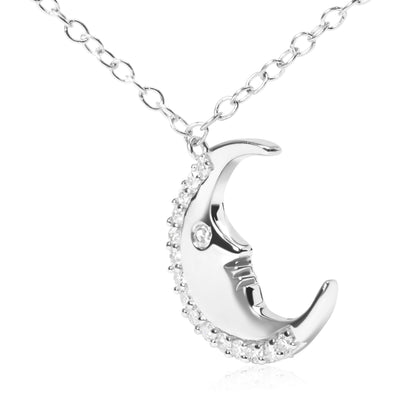 Close-up front angle view of a white metal crescent moon-shaped necklace pendant with round white gemstones set along the outer curve and one gemstone set near the center, hanging from a white metal chain.