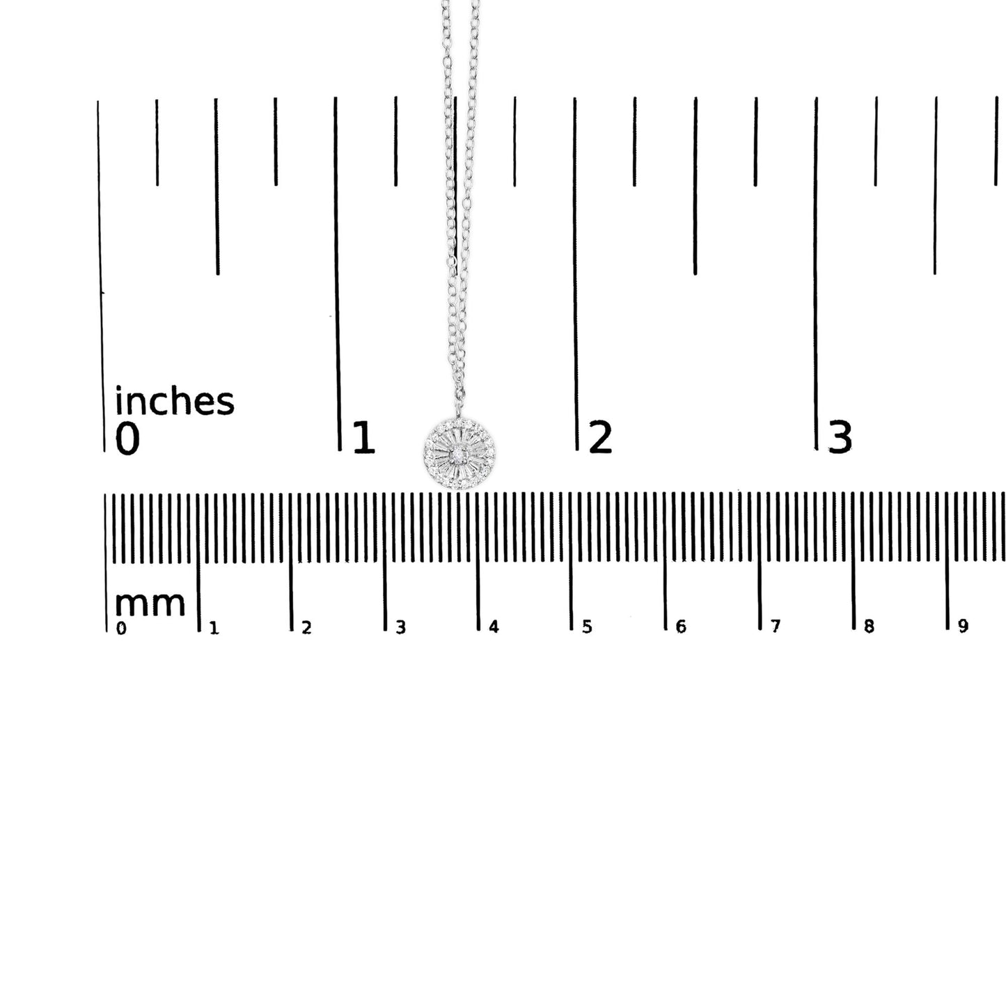 Close-up front view of a white metal necklace with a round pendant featuring one central white gemstone surrounded by multiple smaller white gemstones, shown on a ruler for size reference.