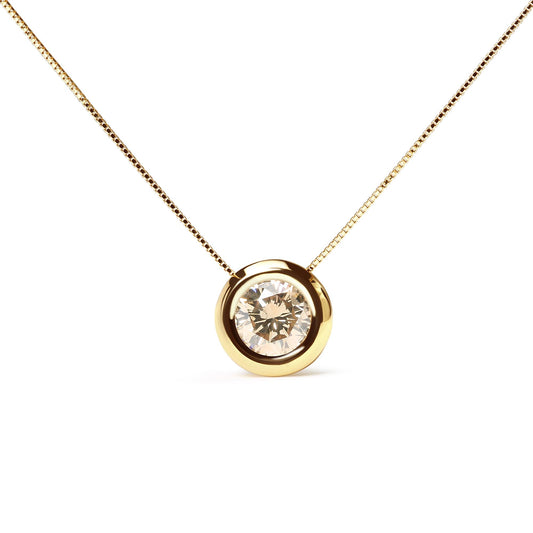 Front-facing close-up of a yellow metal necklace with a round bezel-set champagne-colored gemstone pendant.
