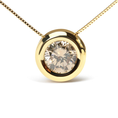 Close-up front view of a yellow metal necklace with a round bezel-set champagne-colored gemstone pendant.