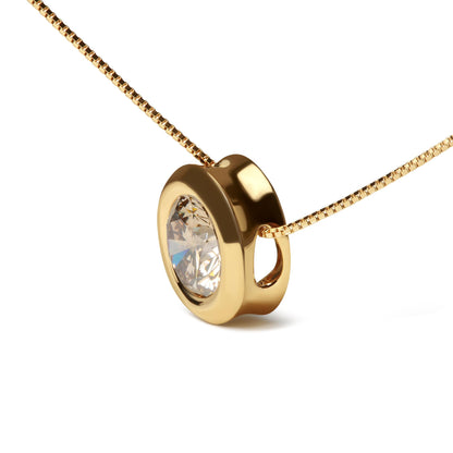 Close-up angled shot of a yellow metal necklace with a round bezel-set champagne-colored gemstone pendant.