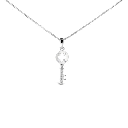 Front angle view of a white metal key-shaped necklace pendant with round white gemstones in prong settings on the circular top and along the shaft, suspended on a box chain.