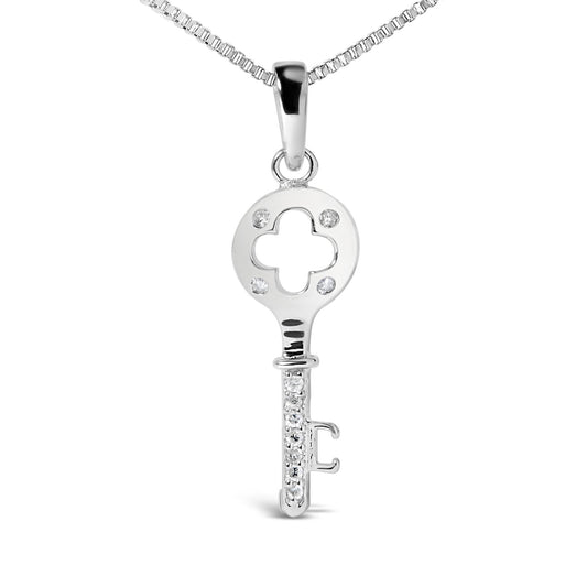 Front view of a white metal key-shaped necklace pendant with round prong-set white gemstones on the bow and shaft, shown against a white background.