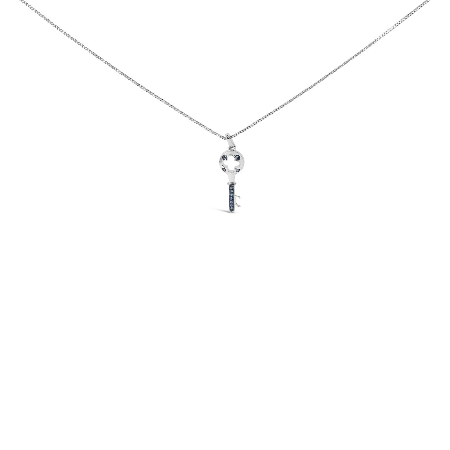 Front-facing shot of a white metal necklace with a key-shaped pendant featuring round blue gemstones in prong settings.