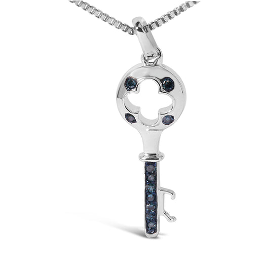 Close-up front view of a white metal key-shaped necklace pendant with round blue gemstones in prong settings, shown hanging from a chain.