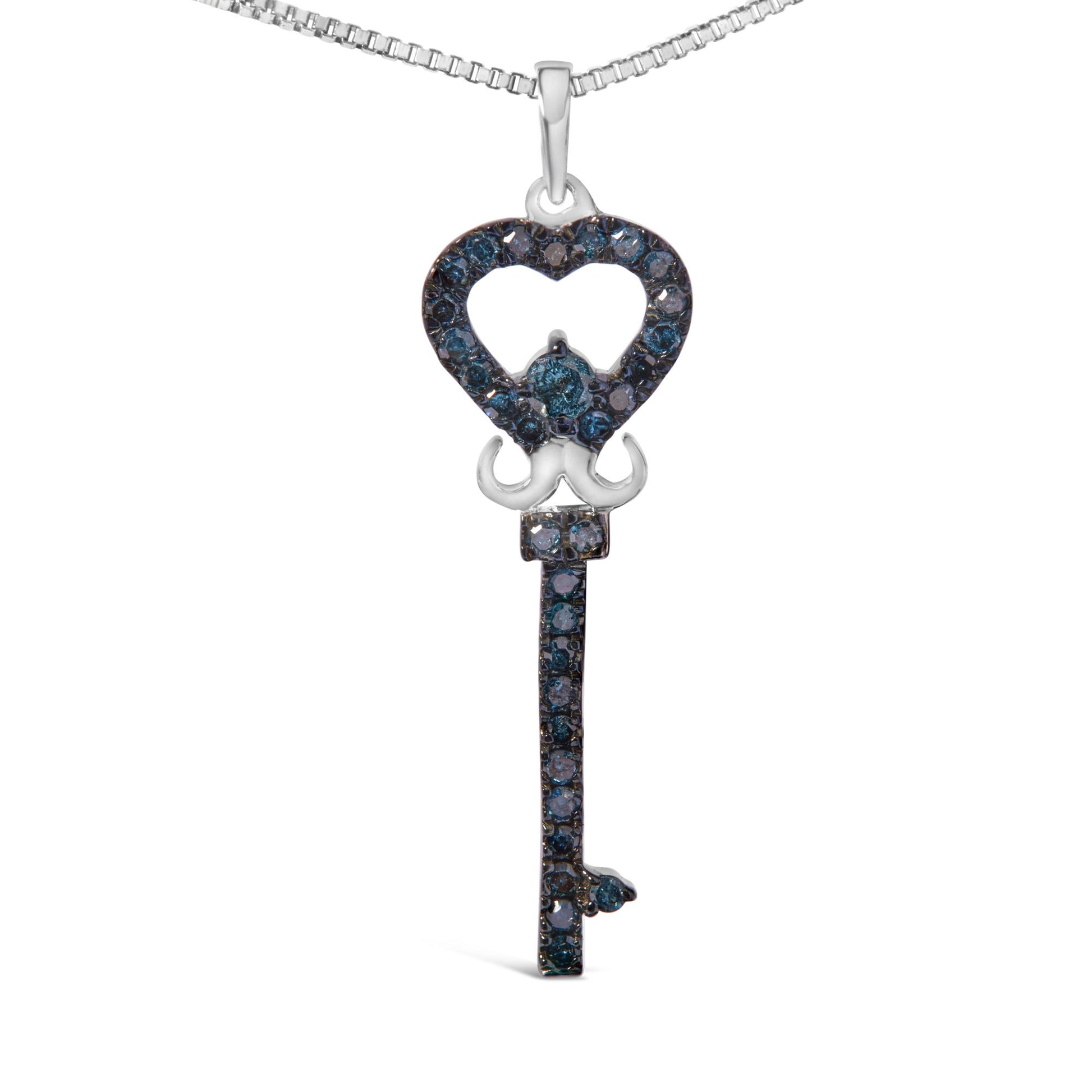 Front-facing shot of a white metal key-shaped necklace pendant adorned with round blue gemstones in prong settings, featuring a heart-shaped top and a vertical shaft below.