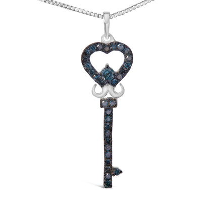 Front-facing shot of a white metal key-shaped necklace pendant adorned with round blue gemstones in prong settings, featuring a heart-shaped top and a vertical shaft below.