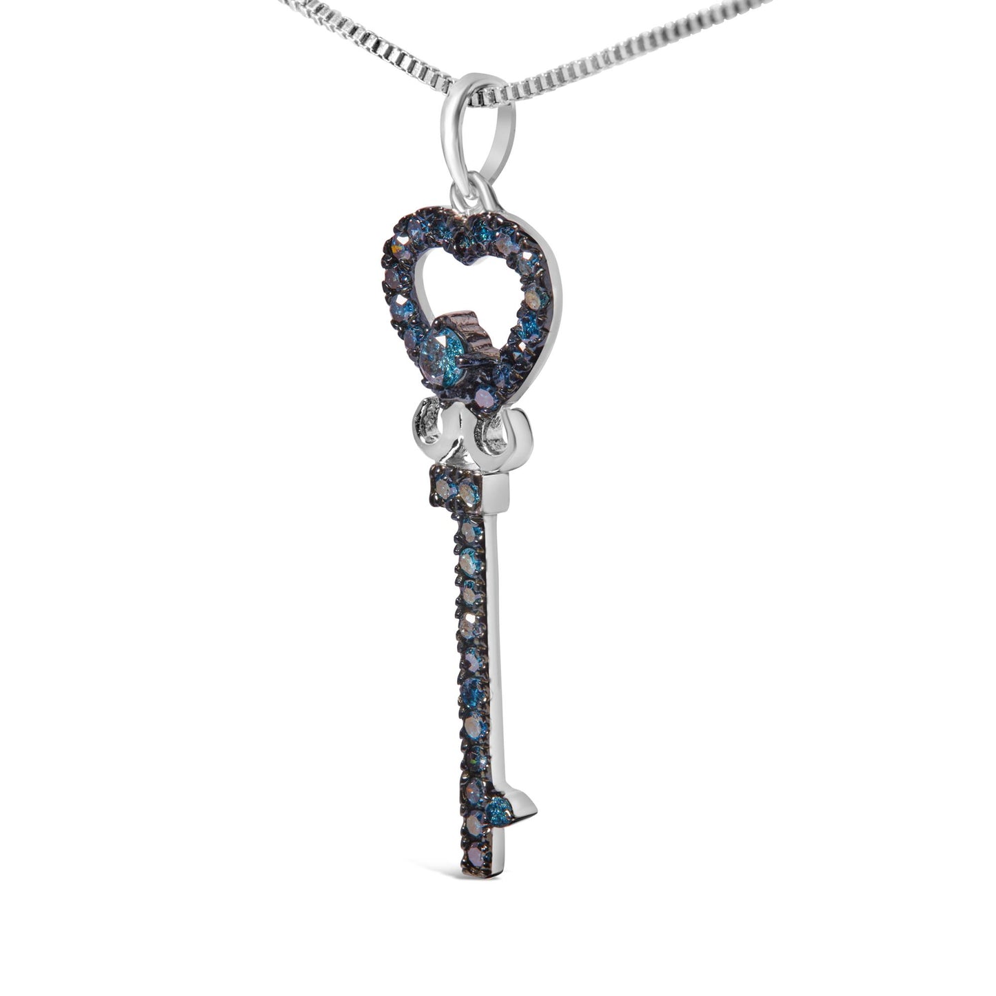 Close-up side angle of a white metal key-shaped necklace pendant adorned with round blue gemstones in prong settings.