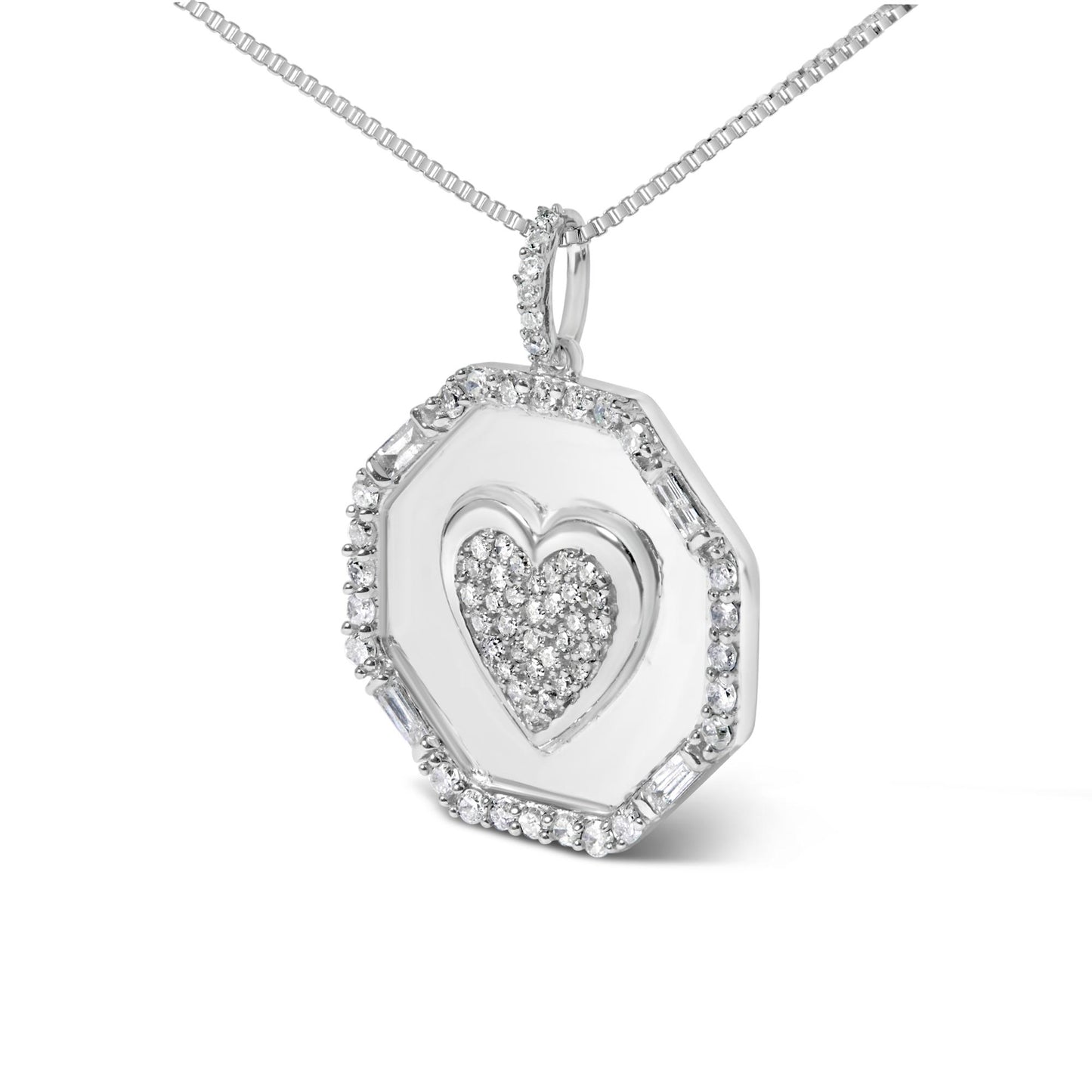 Close-up angled view of a white metal necklace pendant with an octagonal shape, featuring a heart design in the center paved with small white gemstones, surrounded by a border of round and baguette white gemstones, hanging from a chain.