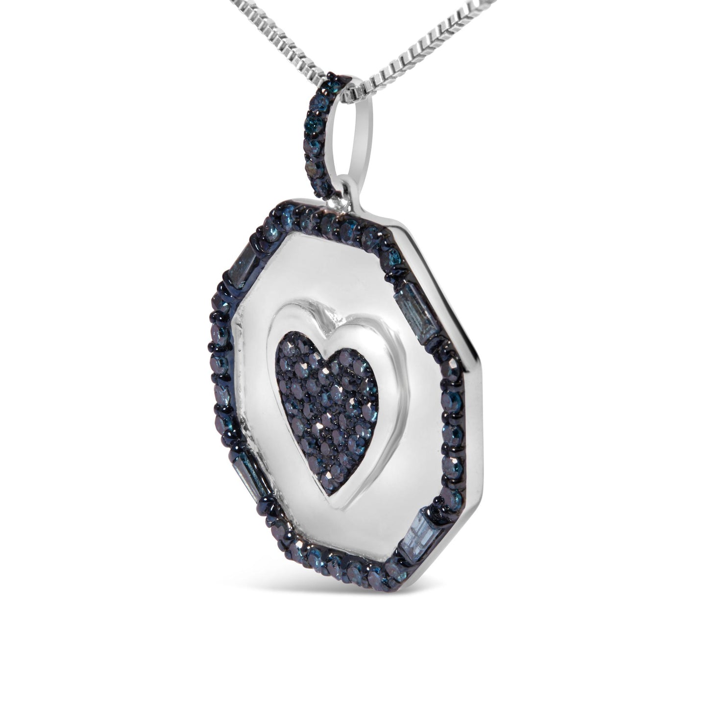 Close-up angled view of a white metal necklace pendant with a heart shape in the center paved with small blue gemstones, surrounded by an octagonal border set with round and baguette blue gemstones, hanging from a white metal chain.