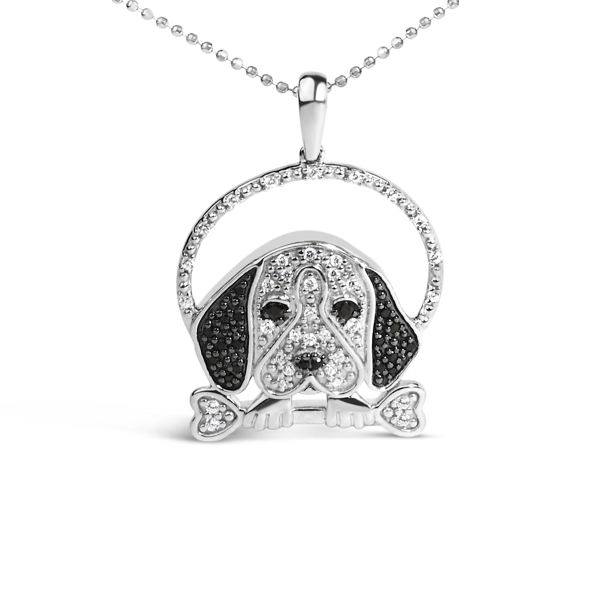Front-facing shot of a white necklace pendant designed as a dog's face. The pendant features round white and black gemstones in micro-pave and prong settings, with a heart-shaped bone detail at the bottom.