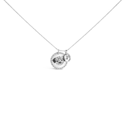Front angle view of a white metal necklace with a circular pendant featuring a dog face design adorned with white and black gemstones and a small round charm with a paw print.