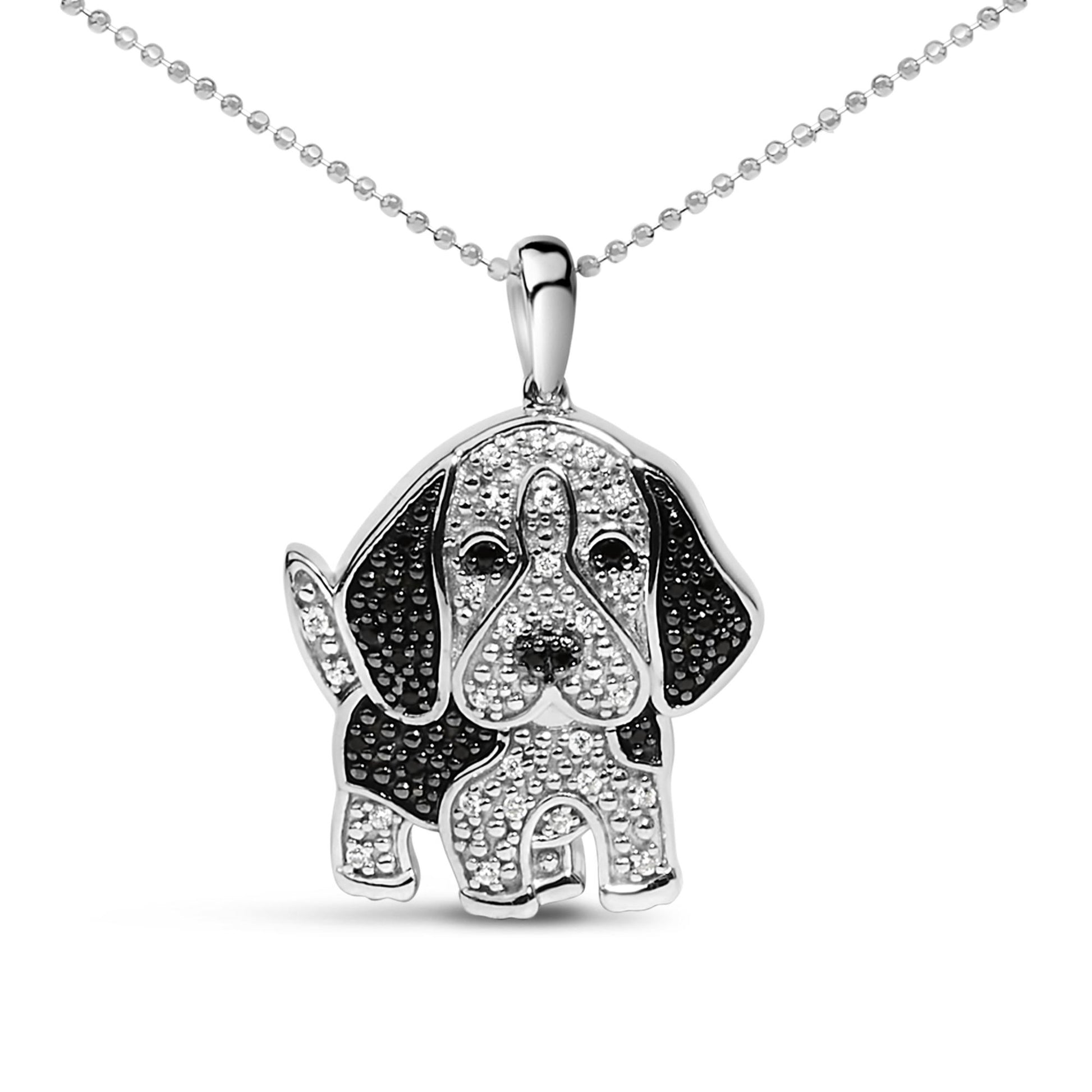 Front-facing shot of a white metal necklace pendant shaped like a dog, adorned with small white and black gemstones in a micro-pave setting.