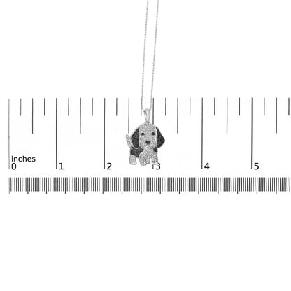 White metal necklace with a dog-shaped pendant featuring micro-pave white and black gemstones, displayed hanging above a ruler for size reference, front angle.