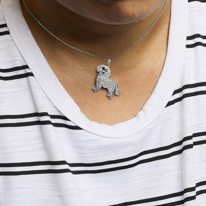 White metal necklace with a dog-shaped pendant encrusted with white and black gemstones, worn on a model, front-facing angle.