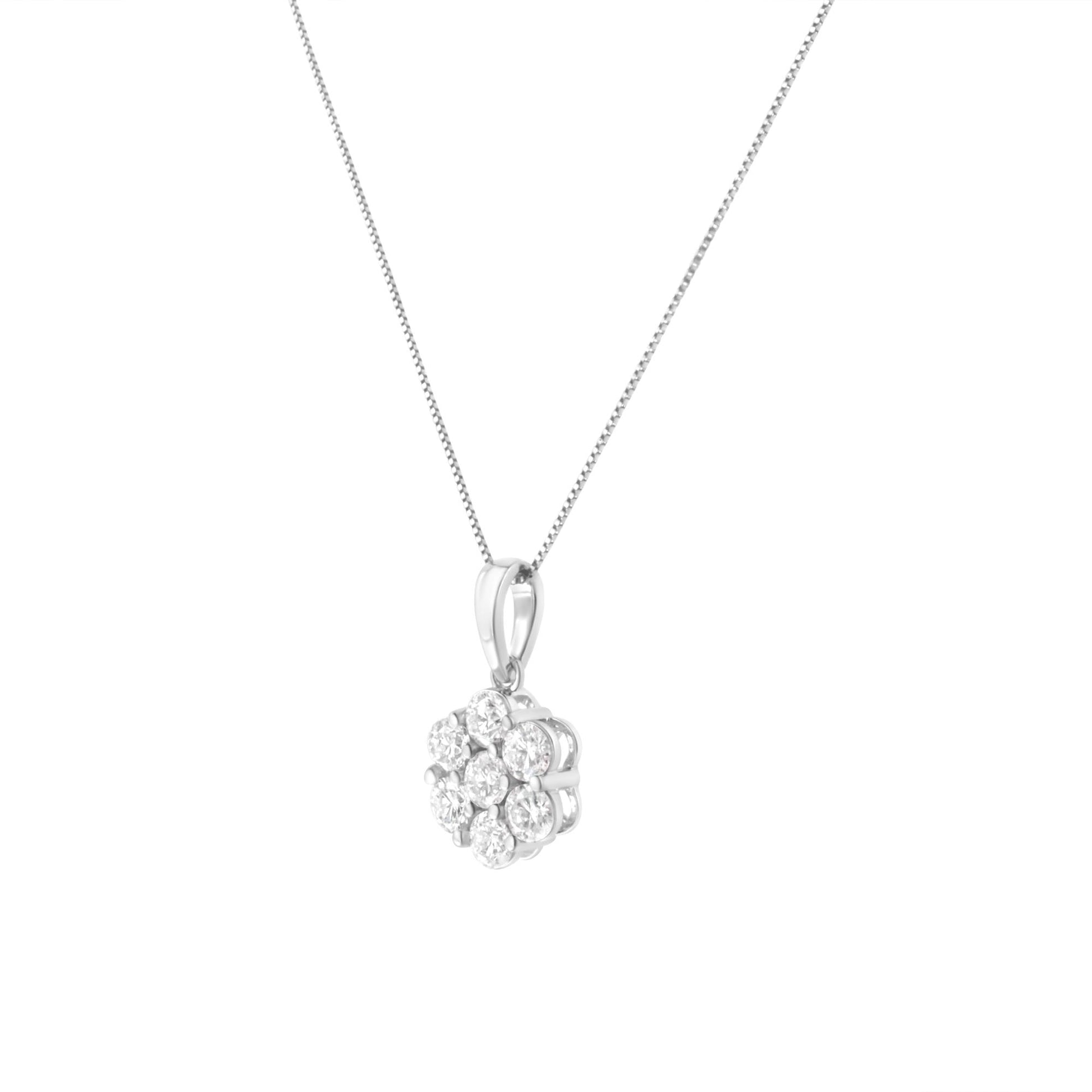 Front angled view of a white metal necklace with a pendant featuring round white gemstones in prong settings.
