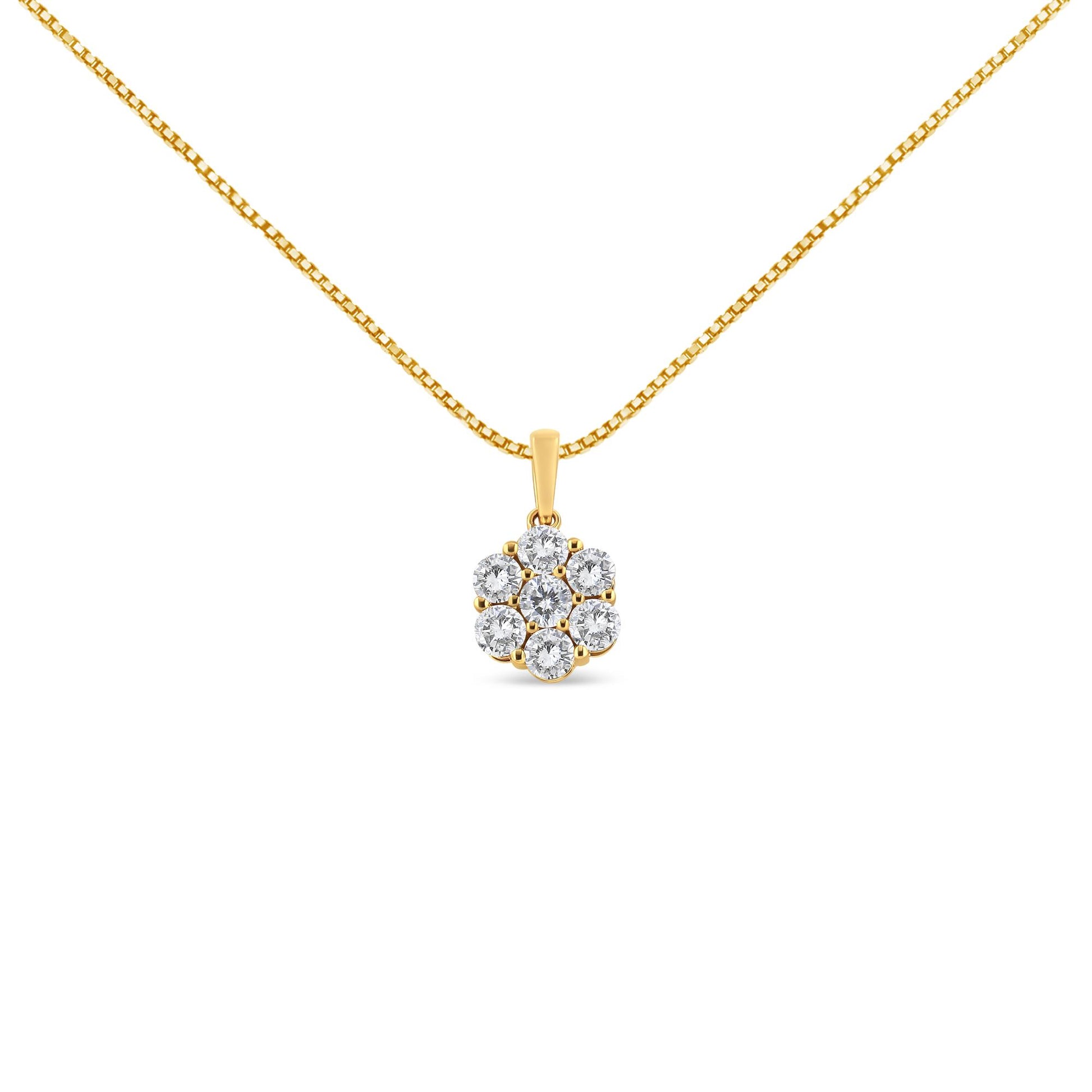 Front-facing shot of a yellow metal necklace with a pendant featuring a cluster of round white gemstones in prong settings.