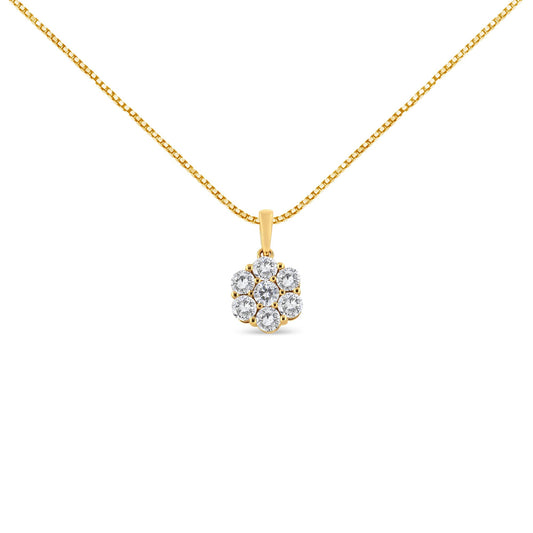 Front-facing shot of a yellow metal necklace with a pendant featuring a cluster of round white gemstones in prong settings.