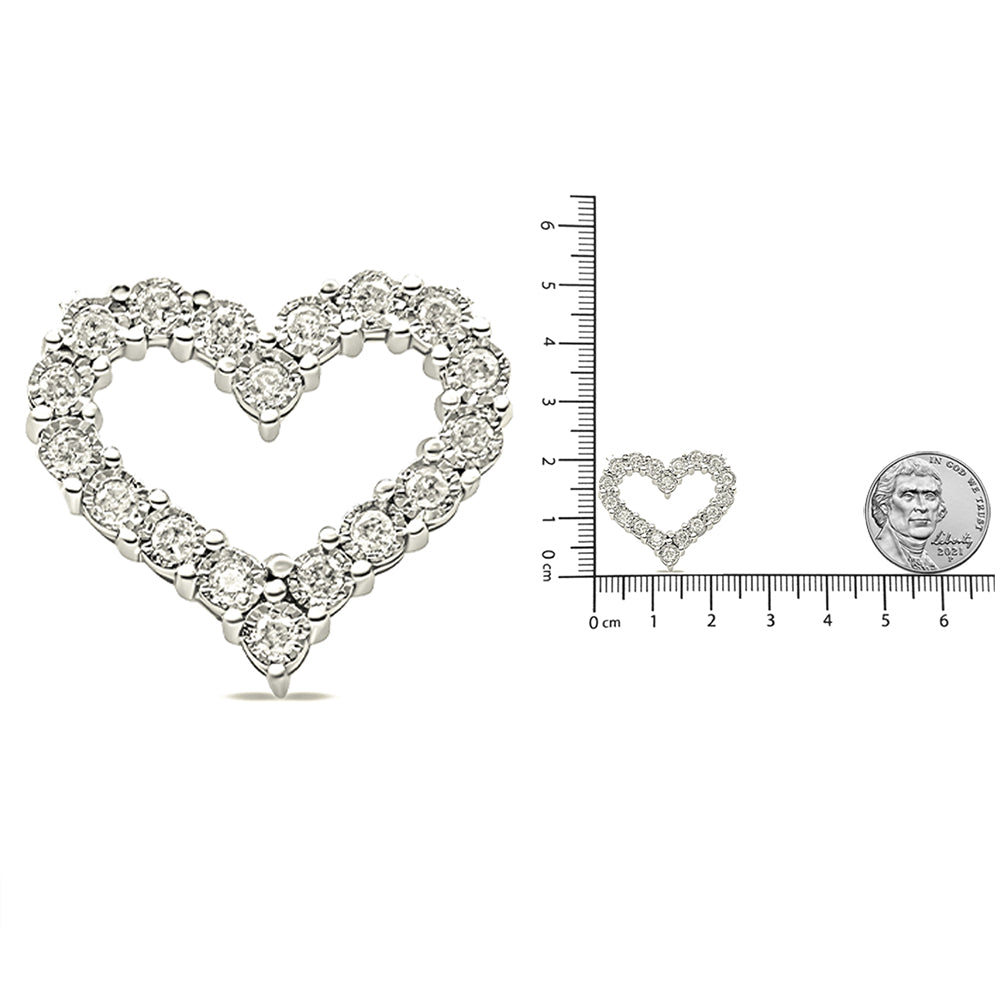 Close-up front angle of a white heart-shaped necklace pendant featuring round prong-set white gemstones, shown next to a ruler and a coin for size reference.