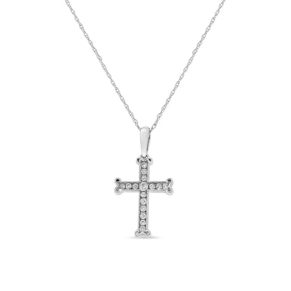 Front-facing shot of a white metal cross pendant necklace with channel-set round white gemstones on the pendant and chain.