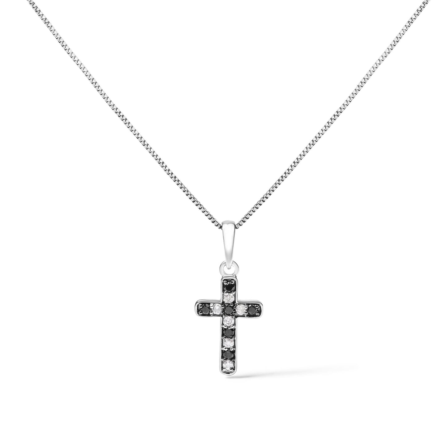 Front view of a white metal cross necklace pendant with alternating black and white round prong-set gemstones, displayed against a white background.