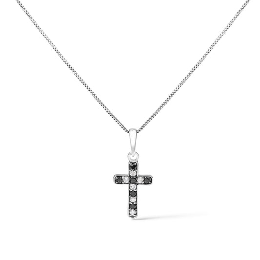 Front view of a white metal cross necklace pendant with alternating black and white round prong-set gemstones, displayed against a white background.